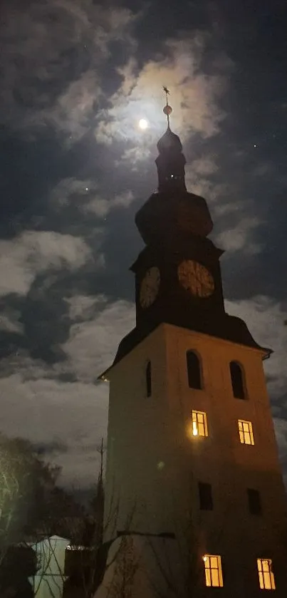 A clock tower illuminated by moonlight in a serene night sky.