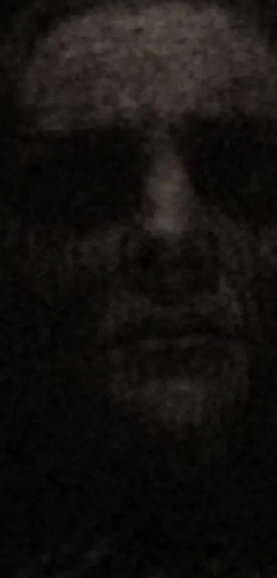 Dark, mysterious face in shadowy mobile wallpaper.