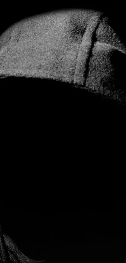 Dark hooded silhouette on black background.