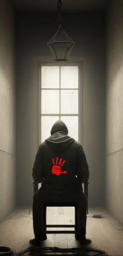 Hooded figure in dark room with red handprint wallpaper.