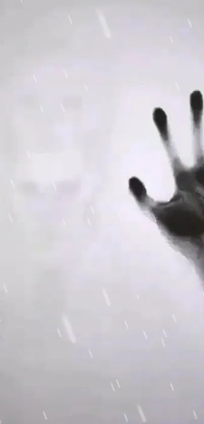 Ghostly hand reaching through fog on a dark mysterious wallpaper.