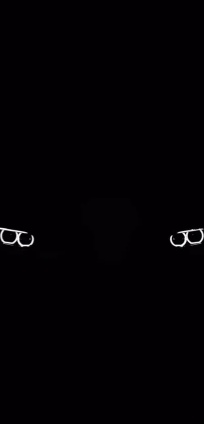 Mysterious glowing glasses on black background.