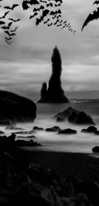 Black-and-white gothic seascape with bats and rocks.