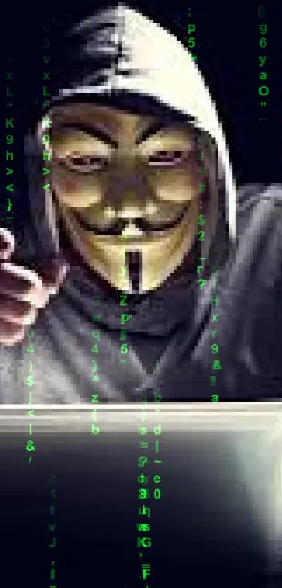 Hacker with anonymous mask typing on a laptop in dark surroundings.