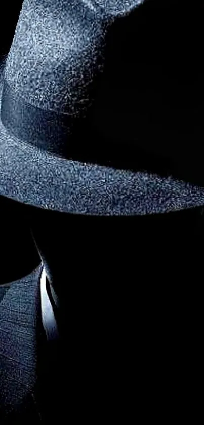 Mysterious silhouette with a fedora hat in dark tones on a wallpaper.