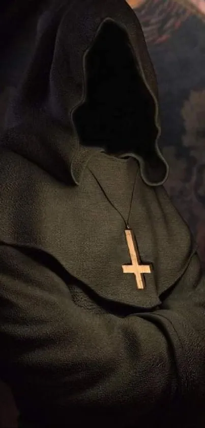 Hooded figure in dark robe with cross necklace, mysterious atmosphere.