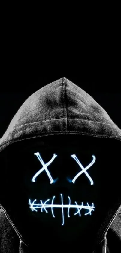 Hooded figure with glowing face on black background.