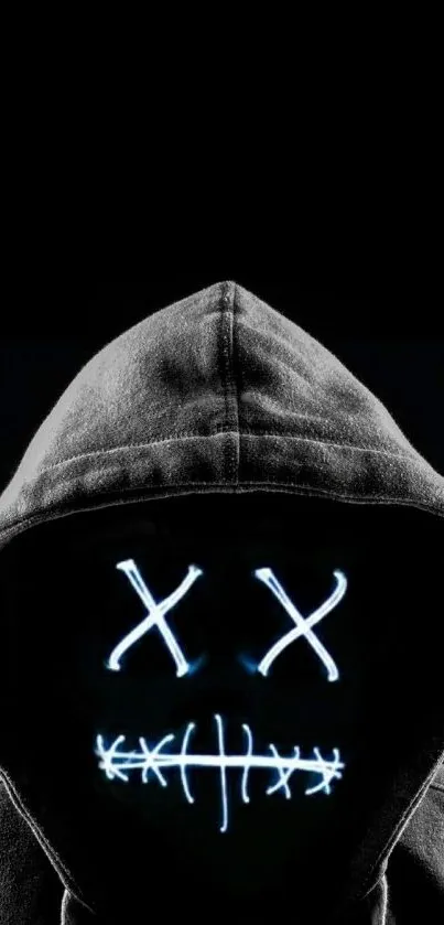 Hooded figure with neon glowing face in dark background wallpaper.