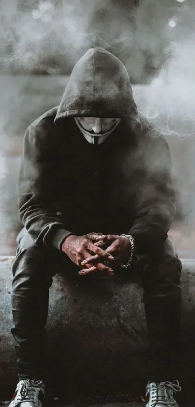 Mysterious hooded figure sitting in fog on a dark background.