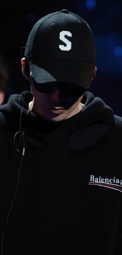 Mysterious figure in black hoodie and cap with a stylish urban vibe.