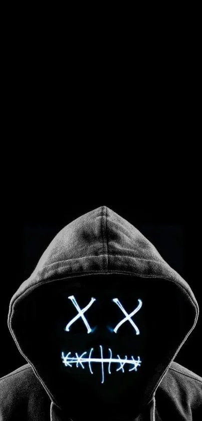 Hooded figure with LED mask on black background.