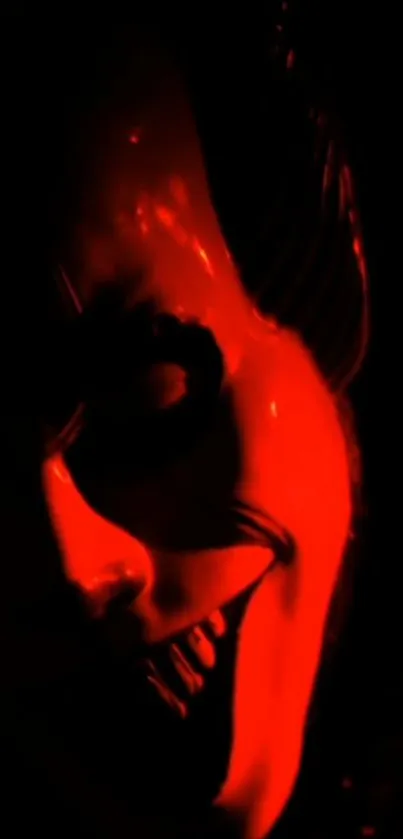 Mysterious red-lit mask in dark shadows.