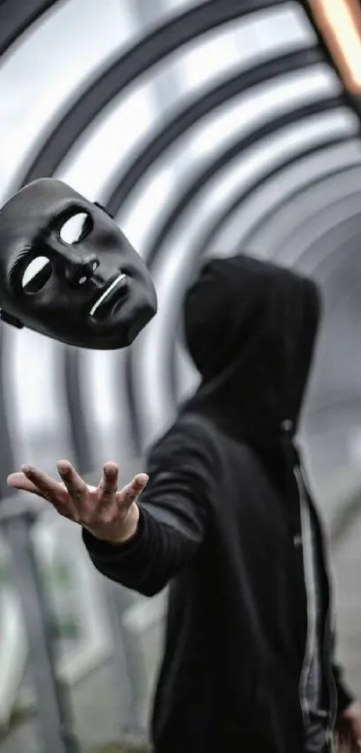 Hooded figure tossing a black mask in an arched walkway.