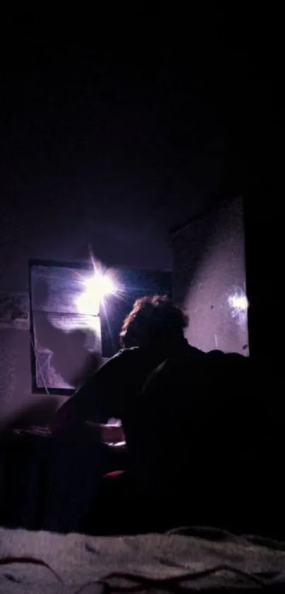 Mysterious silhouette in a dark room with purple lighting.