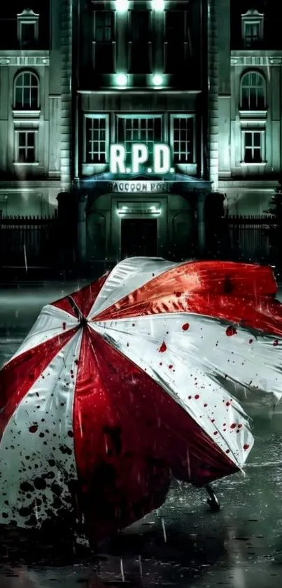 Red and white umbrella in front of RPD building at night.