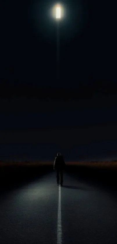 Lone figure walking on dark road under distant light.