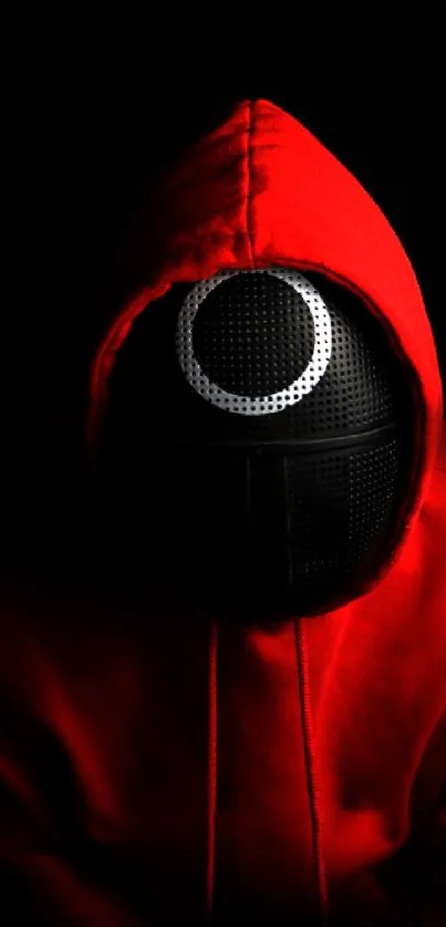 Mysterious figure in red hoodie with dark backdrop.