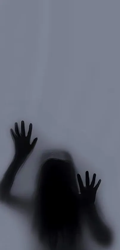 Silhouette of a person behind foggy surface, creating a mysterious feeling.