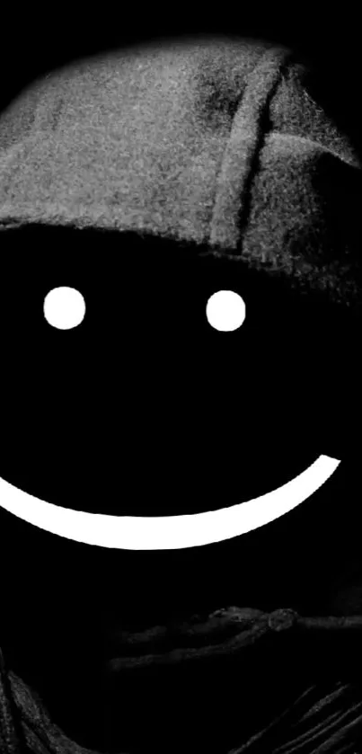 Mysterious smiley face in a hooded cloak on black background.