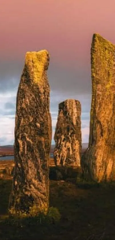 Scottish stone circle under a vibrant sunset sky.