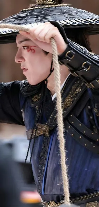 Mysterious warrior in blue attire with hat and rope.