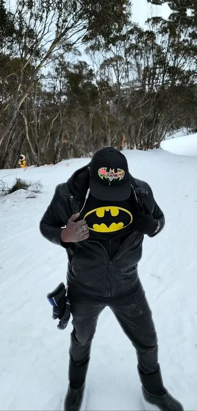 Person in leather jacket reveals superhero logo in snowy forest.