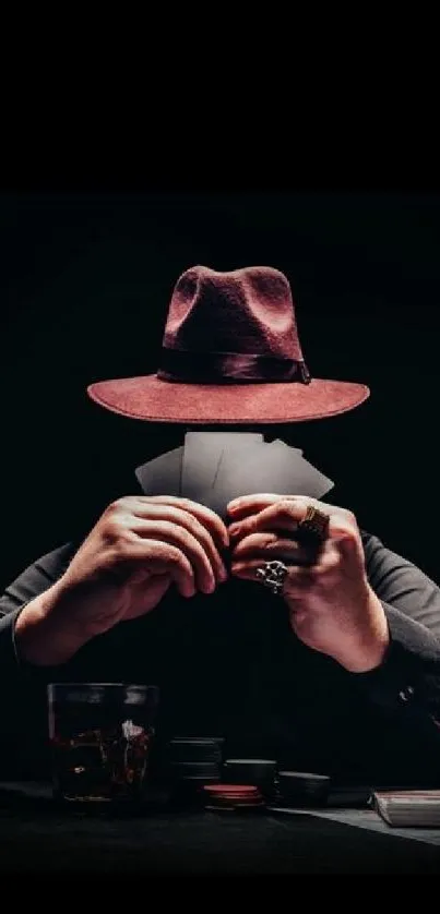 Mysterious poker player in red hat with cards against dark background.