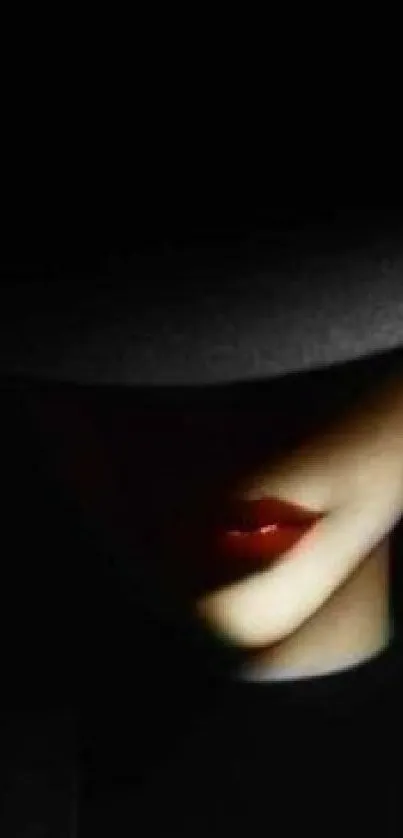 Mobile wallpaper with mysterious woman in shadow, featuring red lips and a dark background.