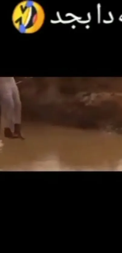 Person walking in desert with brown scenery and water reflection.