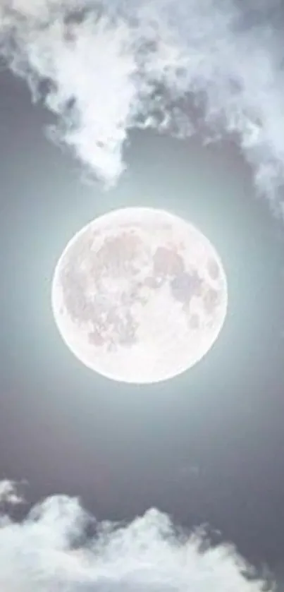 Full moon surrounded by soft clouds in a serene night sky.