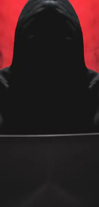 Hooded figure in shadow with red background mobile wallpaper.