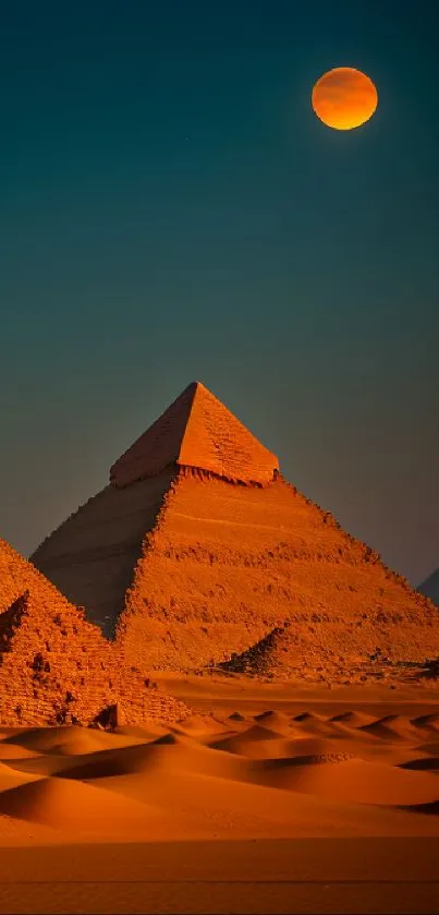 Mobile wallpaper of pyramids under a full moon in the desert night.