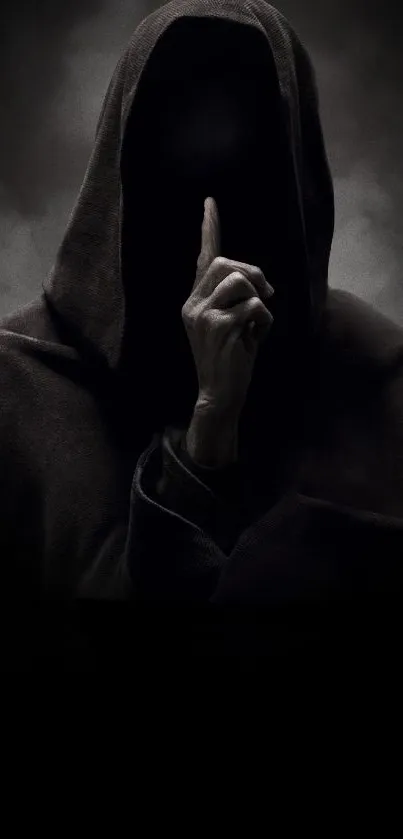 Hooded figure with dark background exuding mystery.