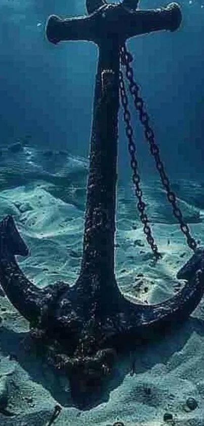 Underwater anchor resting on sandy seabed.