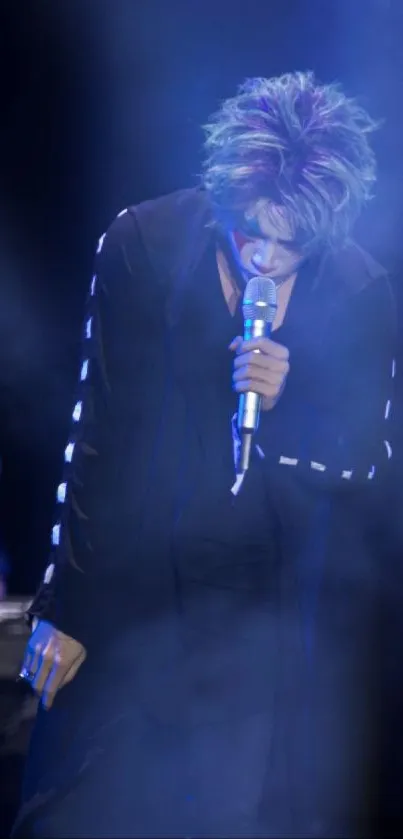 Enigmatic singer in blue hues on stage, mobile wallpaper.