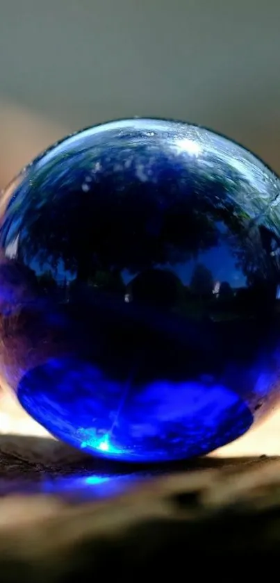 A mystical blue sphere with stunning reflections on a mobile wallpaper.