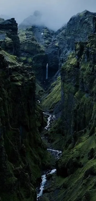 Canyon with lush green cliffs and a distant waterfall.