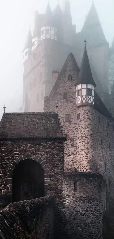 Mystical medieval castle surrounded by fog in a serene landscape.