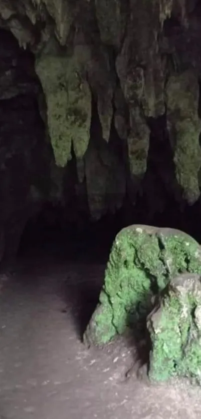 Green rock formations inside a dark cave.