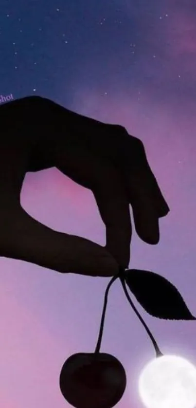 Silhouette of hand holding cherries with moon and purple night sky.