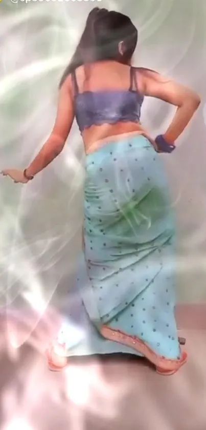 Woman dancing in ethereal light with a vibrant sari.