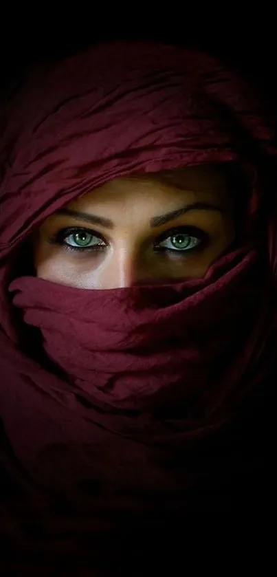 Woman's eyes with maroon veil in dark background.