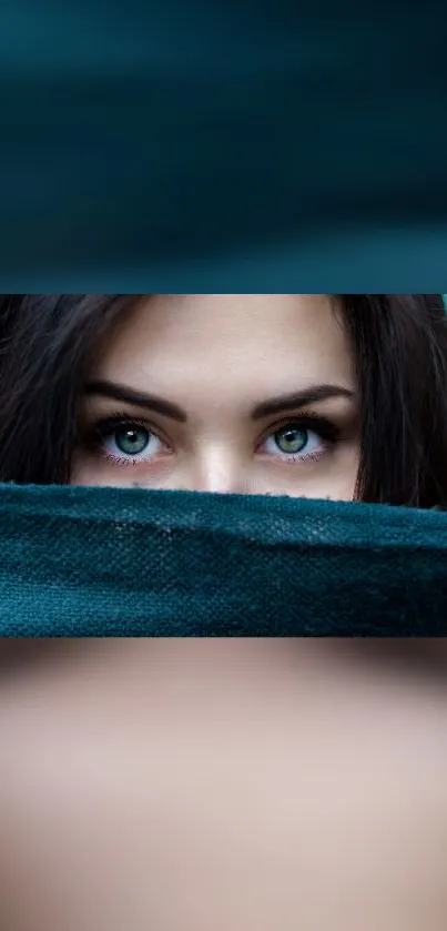 Mobile wallpaper of eyes peeking over teal fabric.