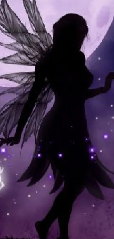 Fairy silhouette with wings against a violet moonlit sky.