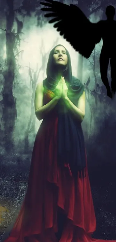 Woman in red dress prays in mystical forest with silhouetted winged figure.