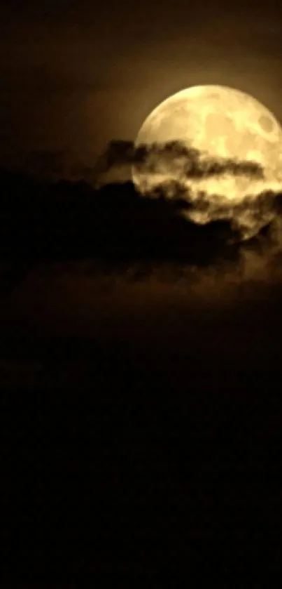 Full moon shining through dark clouds at night.