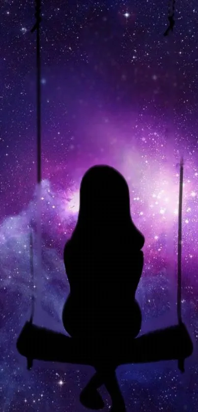 Silhouette on a swing with purple galaxy background.