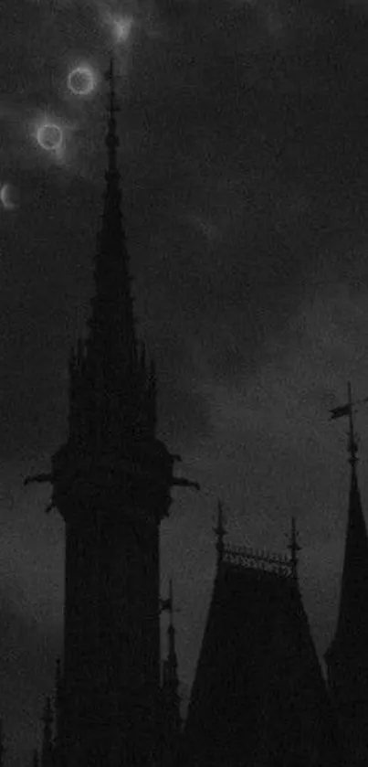 Gothic spires under a moonlit sky with dark clouds.