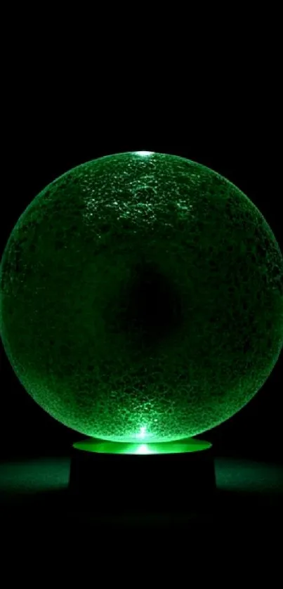 Mystical green sphere emitting a soft glow on a dark background.