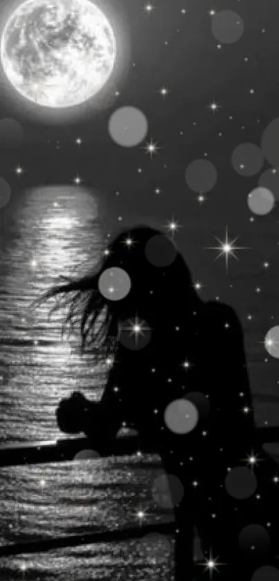 Silhouette against a moonlit ocean with stars.